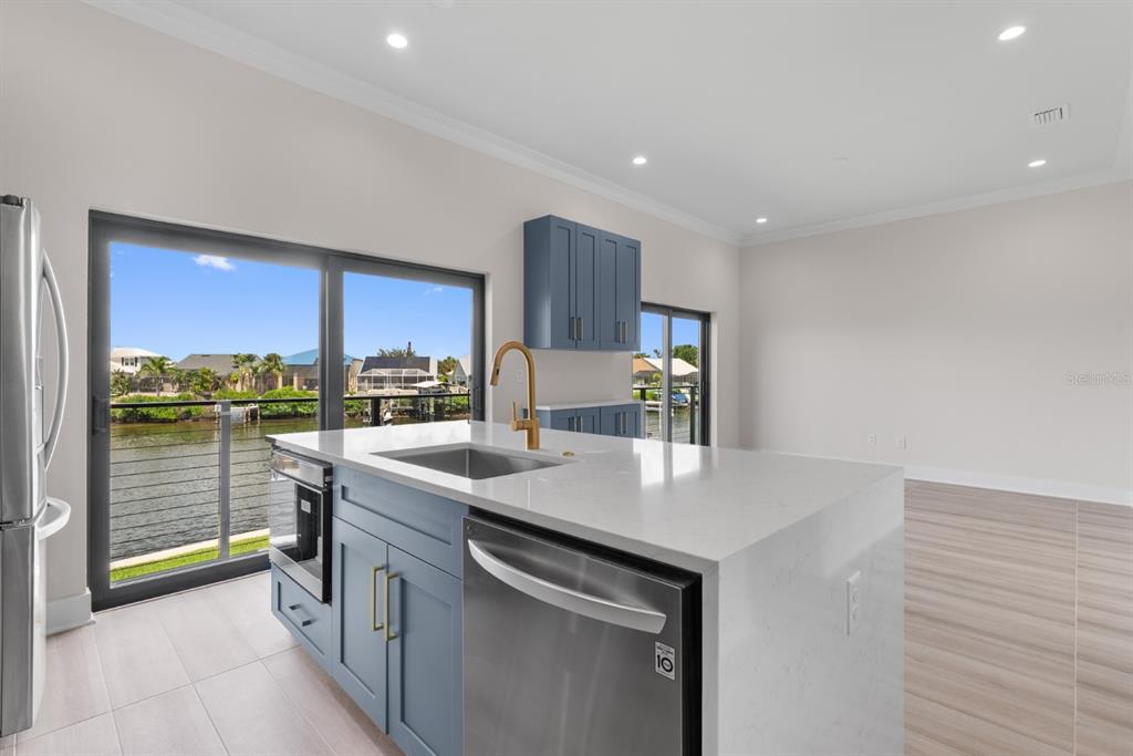 775 Gran Kaymen Way Apollo Beach, FL 33572 - Photo 9 of 43 a kitchen with stainless steel appliances granite countertop a sink and a stove