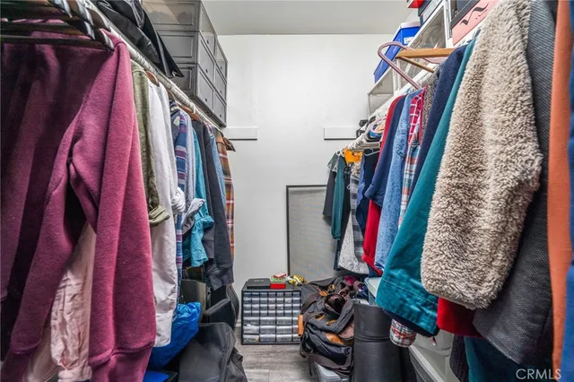 a view of walk in closet with clothes