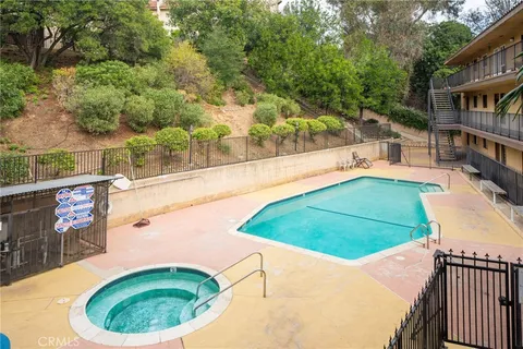 a view of a swimming pool with an outdoor seating