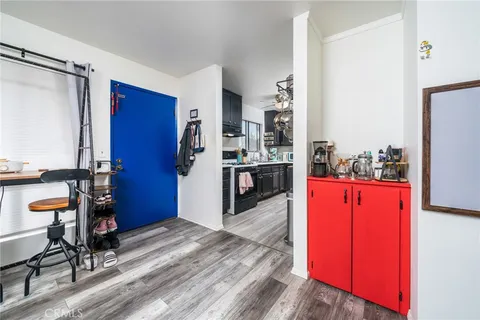 a kitchen with stainless steel appliances kitchen island granite countertop wooden cabinets and a refrigerator