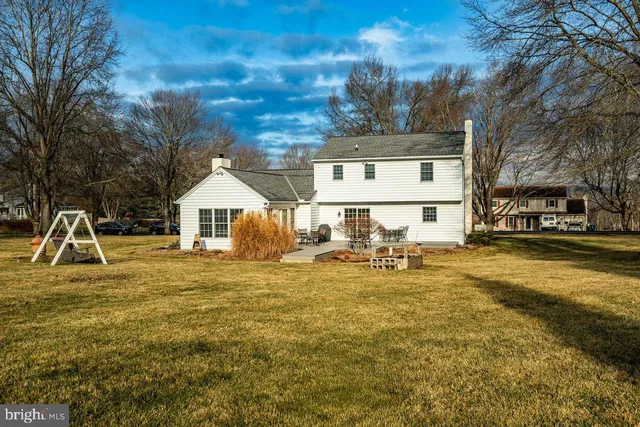 a view of a house with swimming pool and sitting area