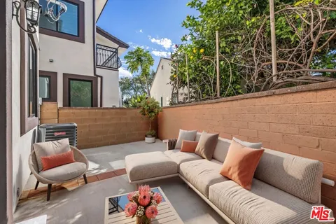 a outdoor living space with furniture and a potted plant