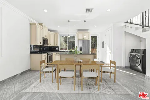 a large kitchen with a table and chairs