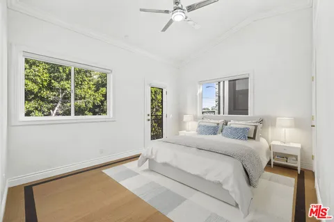 a bedroom with a large bed and a chandelier