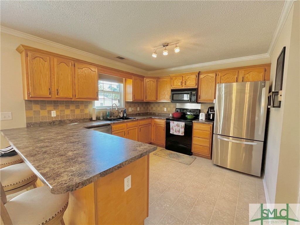 202 Wood Duck Way Springfield, GA 31329 - Photo 13 of 41 Fully Equipped Kitchen with Breakfast Bar