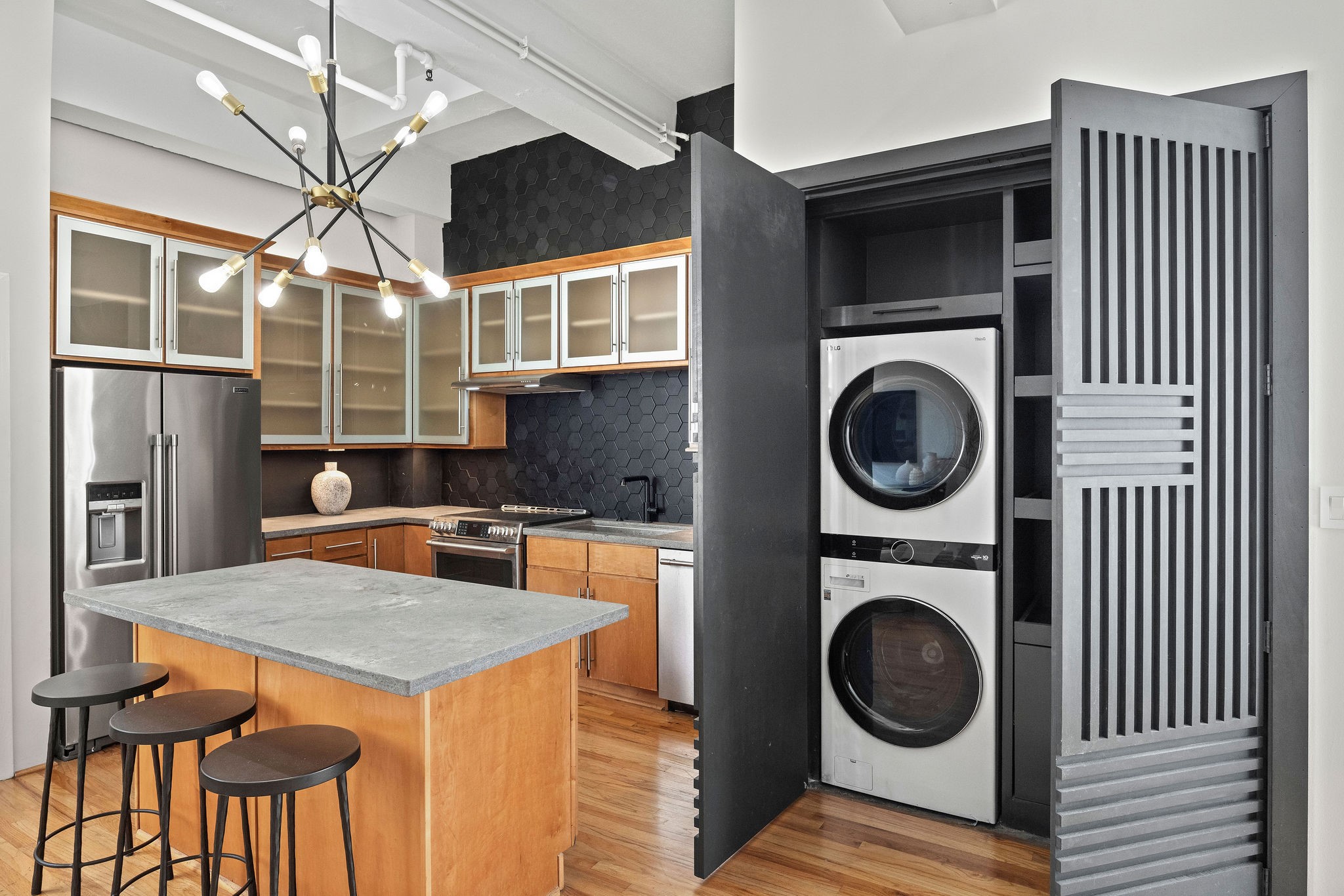 705 Main Street, Unit 516 Houston, TX 77002 - Photo 19 of 22 Custom accent doors reveal a dedicated laundry area with built-in storage solutions.