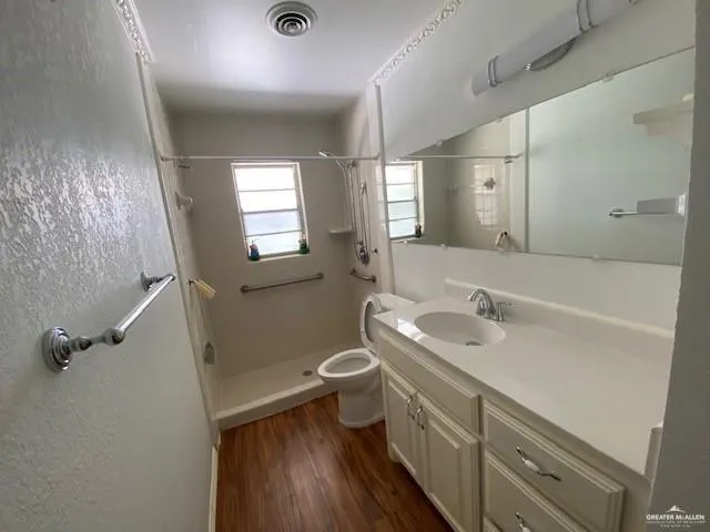 a bathroom with a double vanity sink toilet and shower