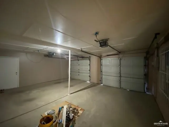 a kitchen with a sink a refrigerator a window and cabinets