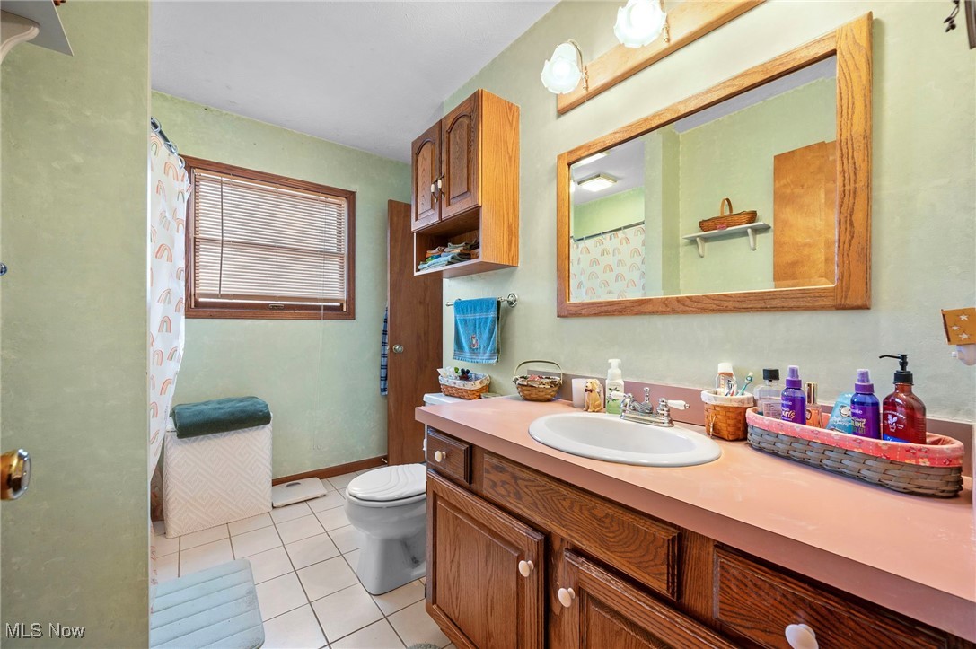 636 Wall Road Wadsworth, OH 44281 - Photo 26 of 35 Full bathroom featuring toilet, vanity, baseboards, and tile patterned floors