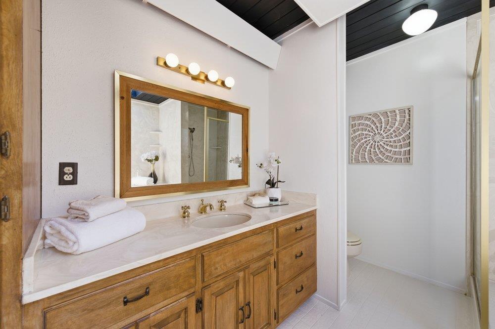 2203 Allegheny Way San Mateo, CA 94402 - Photo 22 of 56 a bathroom with a double vanity sink and a mirror