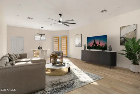a bedroom with a large bed and a chandelier