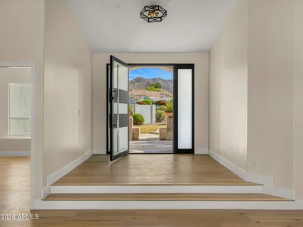 a view of a hallway view with wooden floor and staircase