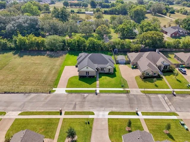 an aerial view of residential houses with outdoor space and swimming pool