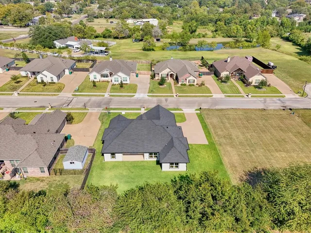 an aerial view of residential houses with yard and swimming pool