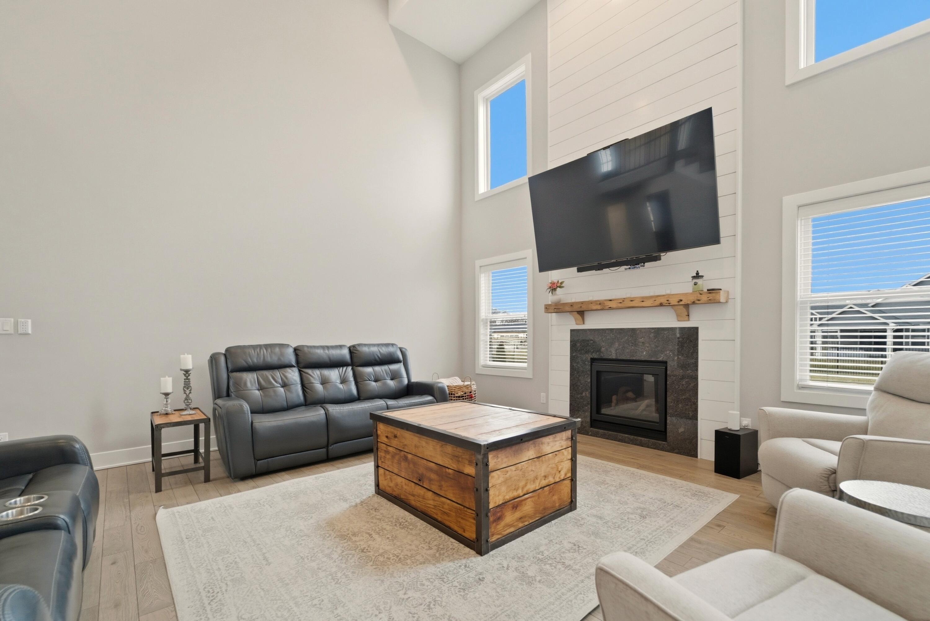 11200 Oak Ridge Court Crown Point, IN 46307 - Photo 13 of 43 a living room with furniture a flat screen tv and a fireplace