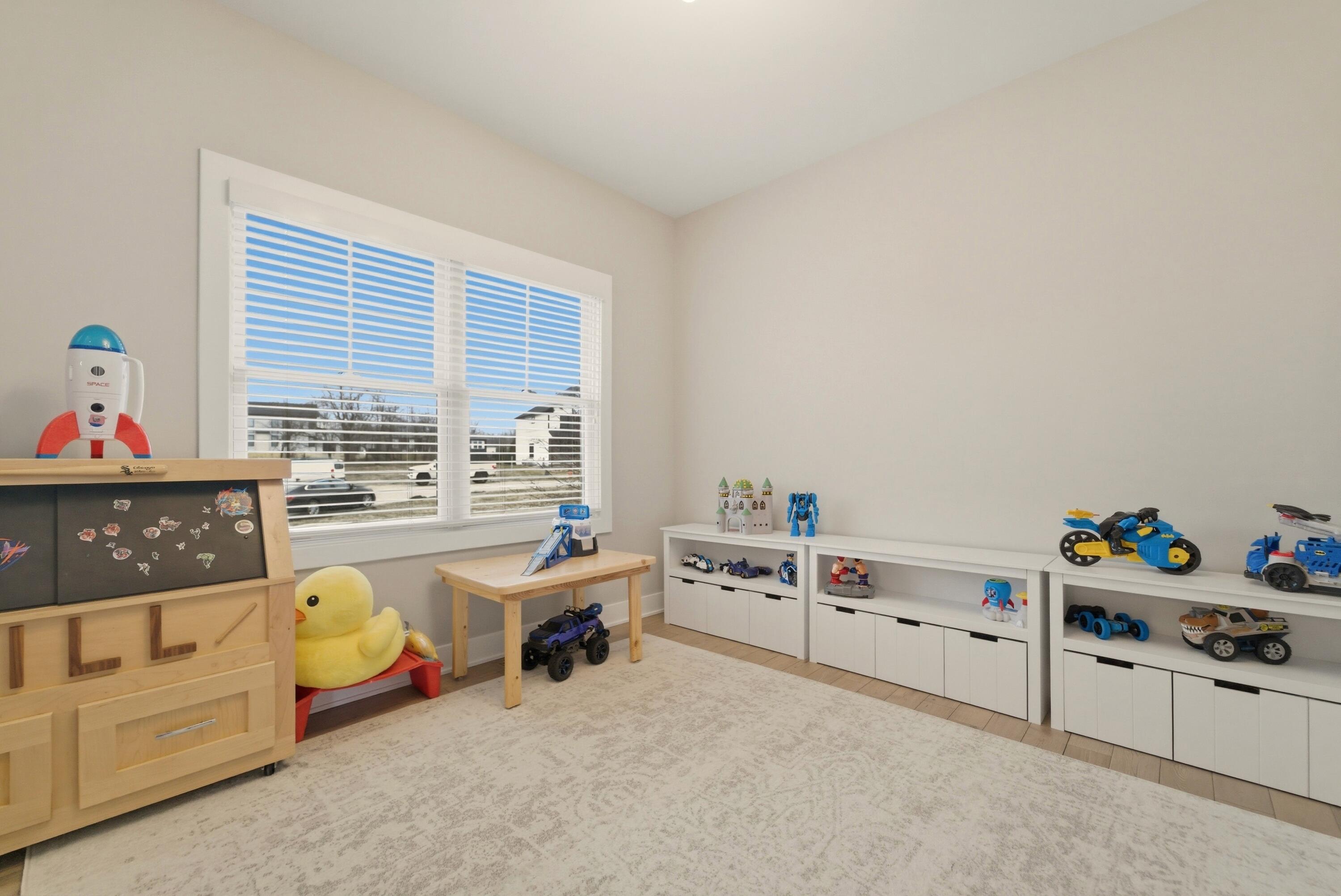 11200 Oak Ridge Court Crown Point, IN 46307 - Photo 19 of 43 a bedroom with furniture and a window
