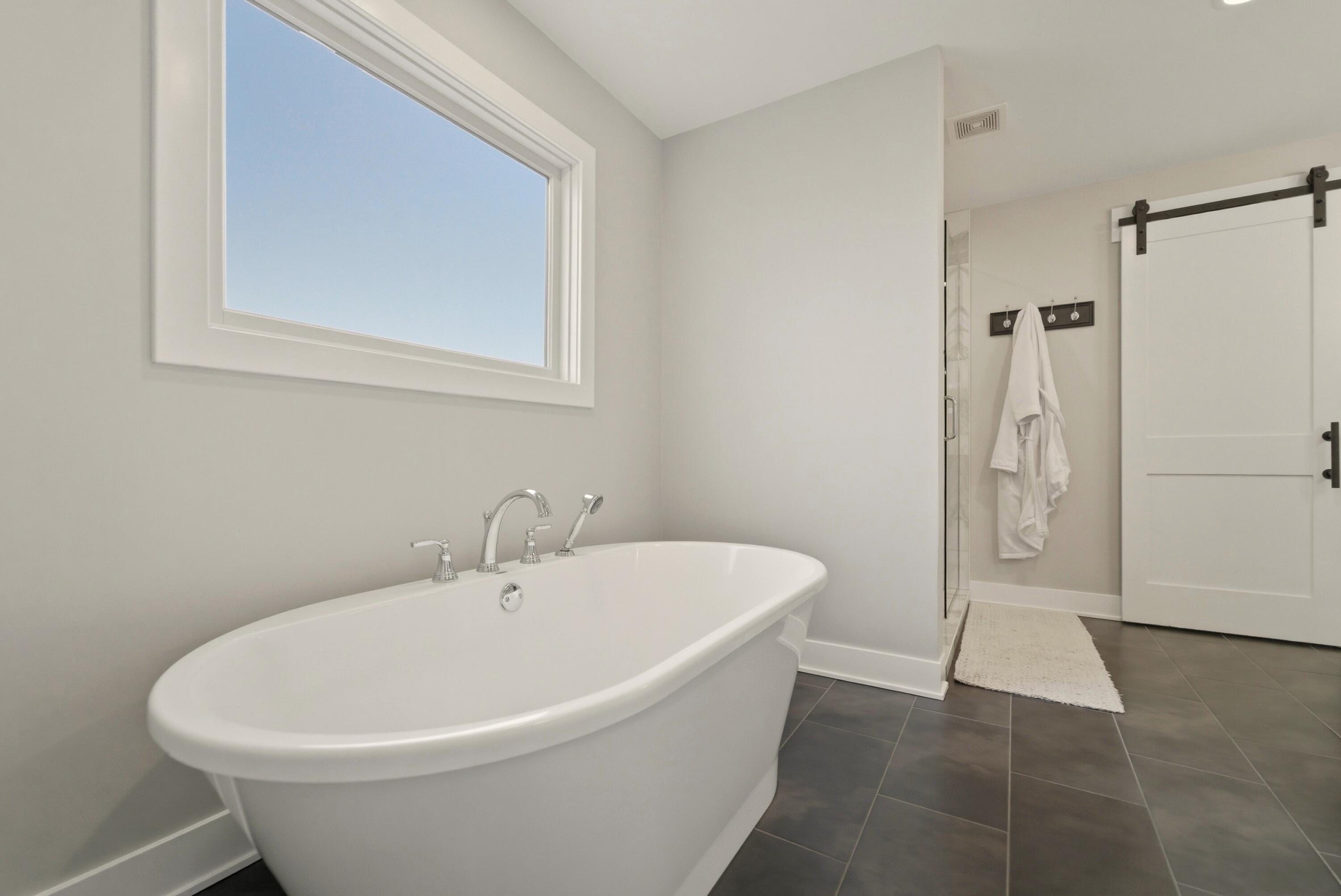 11200 Oak Ridge Court Crown Point, IN 46307 - Photo 26 of 43 a white bath tub sitting in a bathroom
