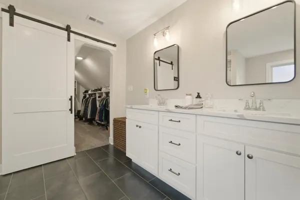a bathroom with a shower and a glass door
