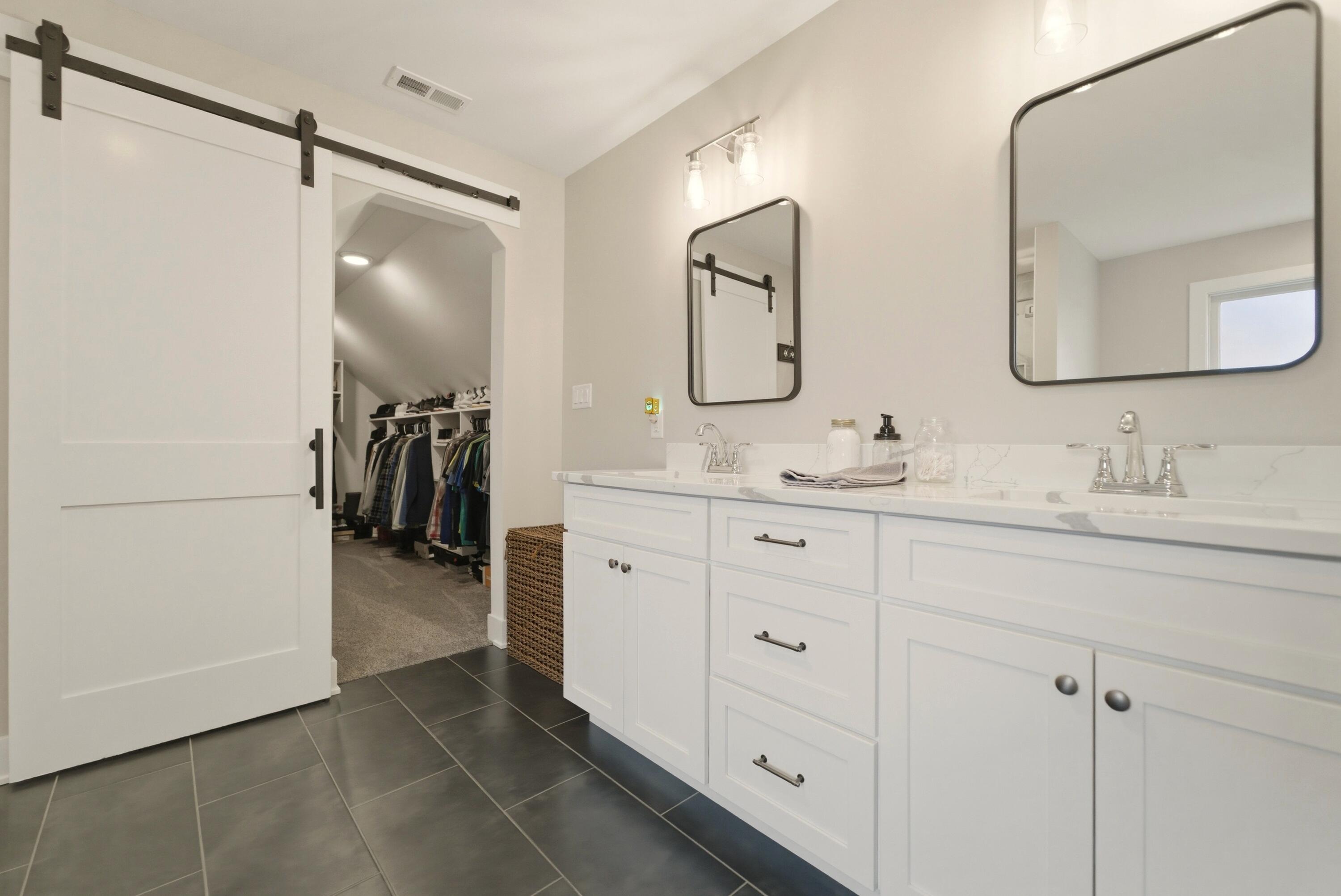 11200 Oak Ridge Court Crown Point, IN 46307 - Photo 27 of 43 a bathroom with a double vanity sink and a mirror