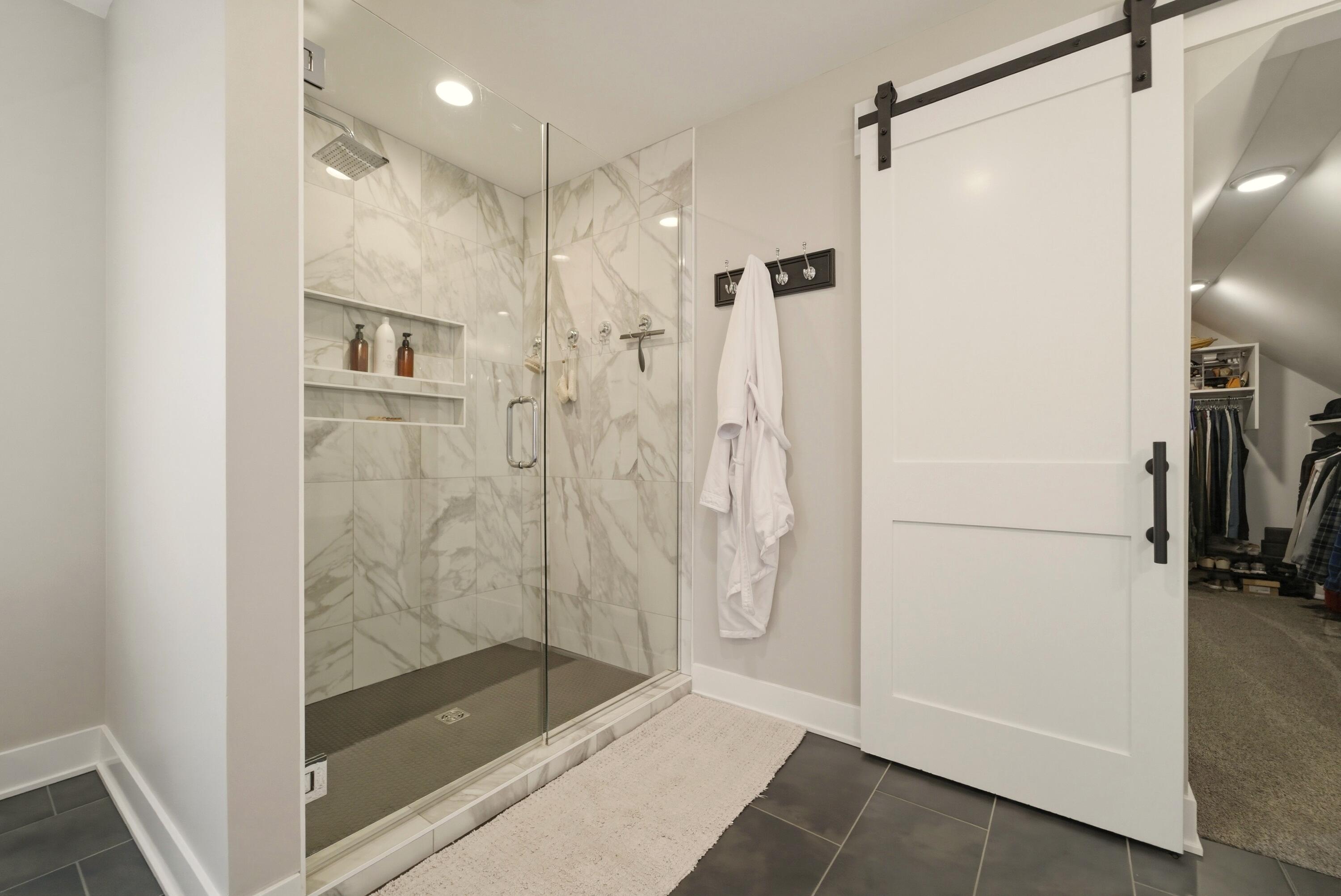 11200 Oak Ridge Court Crown Point, IN 46307 - Photo 29 of 43 a bathroom with a shower and a glass door