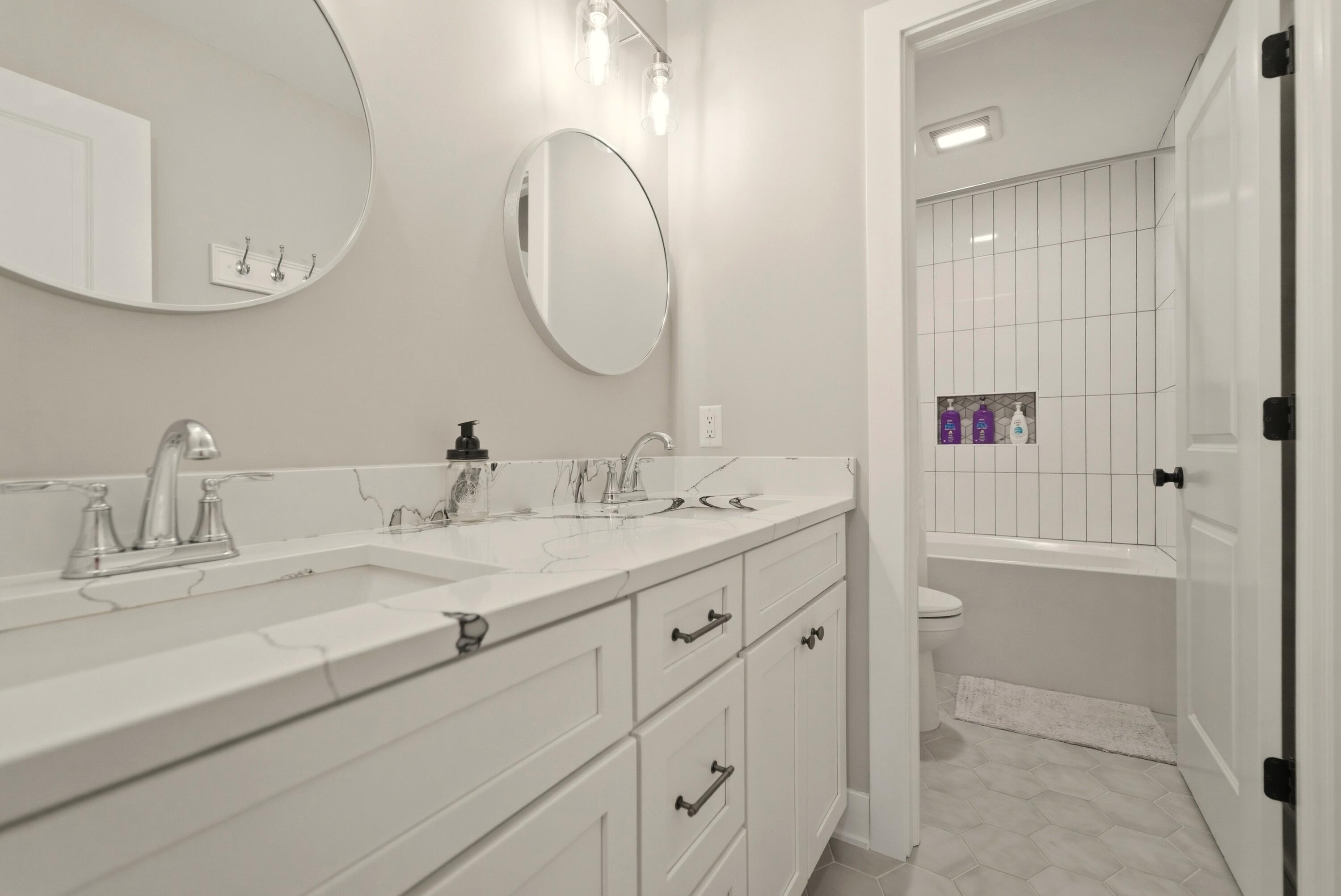 11200 Oak Ridge Court Crown Point, IN 46307 - Photo 32 of 43 a bathroom with a double vanity sink and a mirror