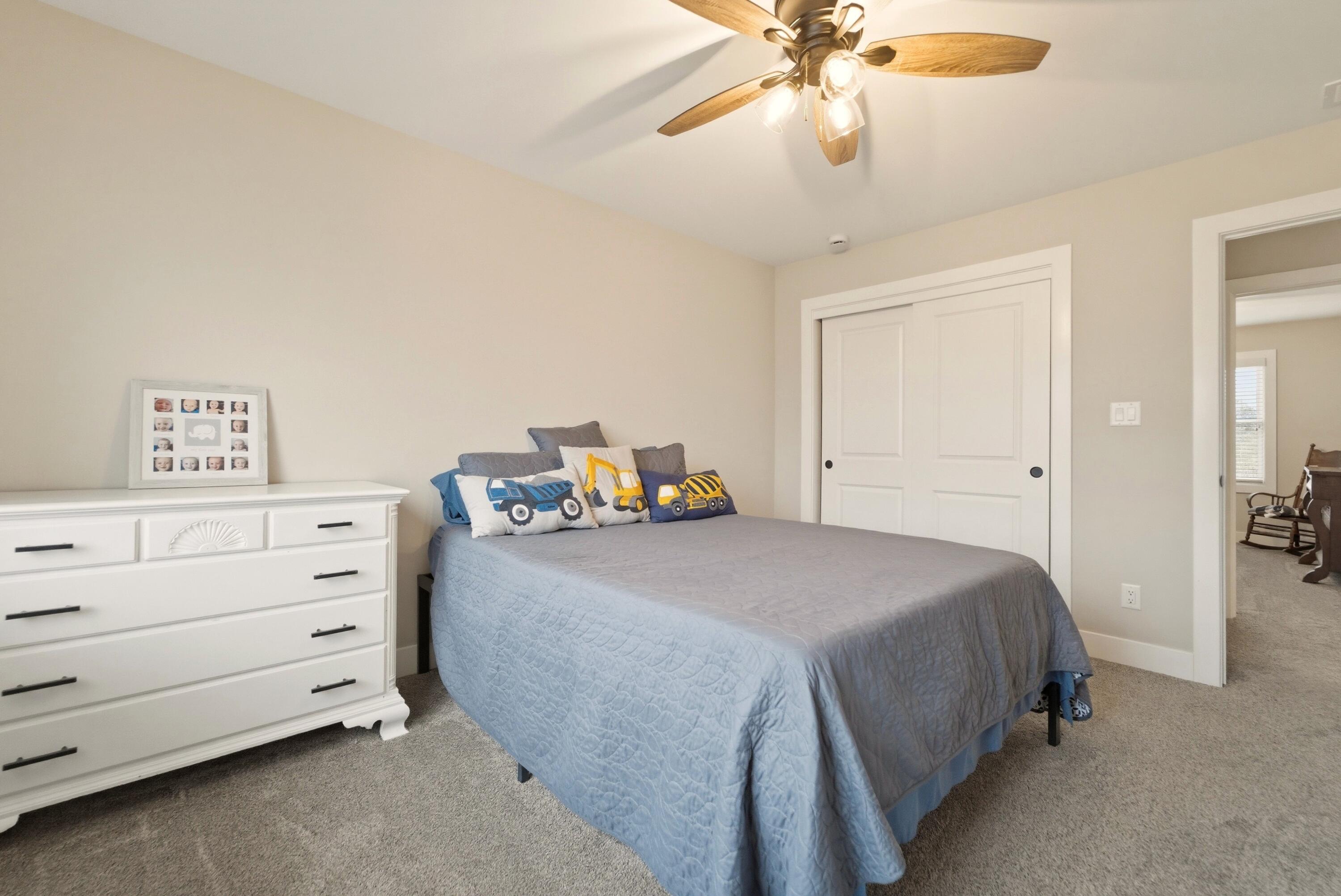 11200 Oak Ridge Court Crown Point, IN 46307 - Photo 35 of 43 a bedroom with a bed and a chandelier