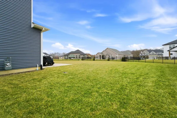 a front view of a house with yard and ocean view