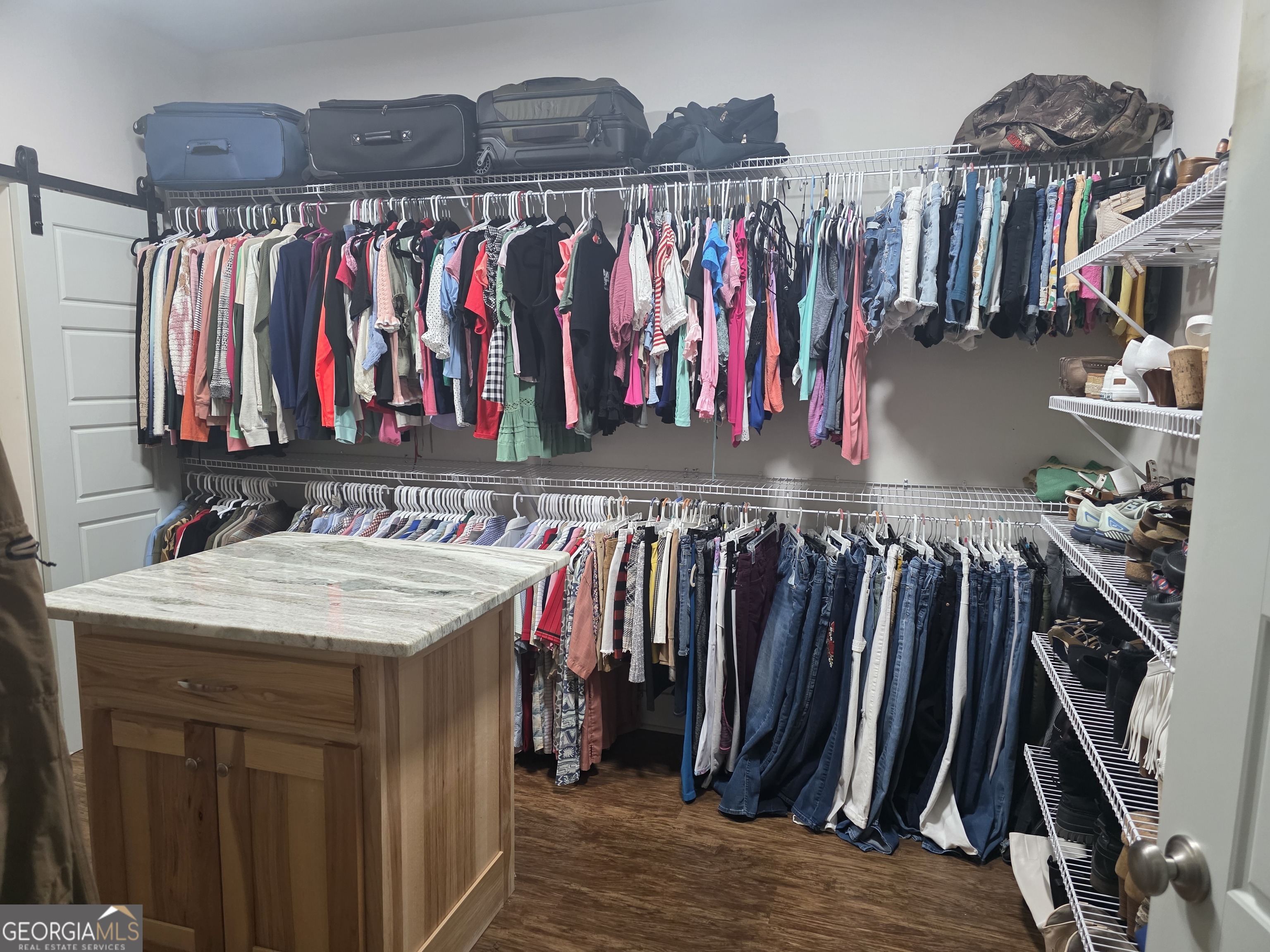 3060 Eatonton Road Madison, GA 30650 - Photo 31 of 65 a view of walk in closet with clothes