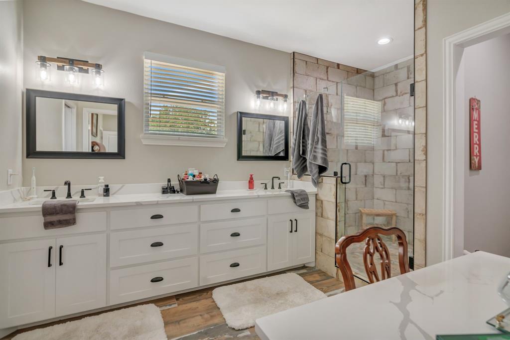129 Whiskey Rnch Road Runaway Bay, TX 76426 - Photo 22 of 39 a bathroom with a granite countertop sink mirror and double