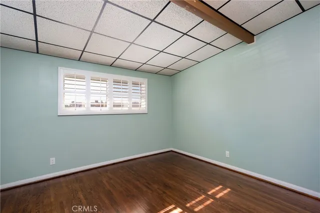 a view of a room with wooden floor and natural light