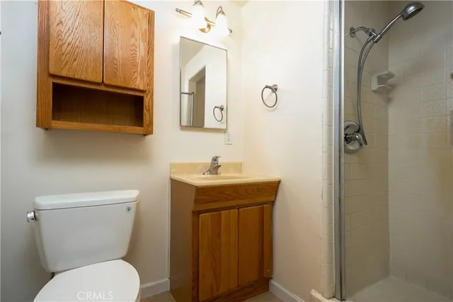 a bathroom with a toilet sink shower and mirror