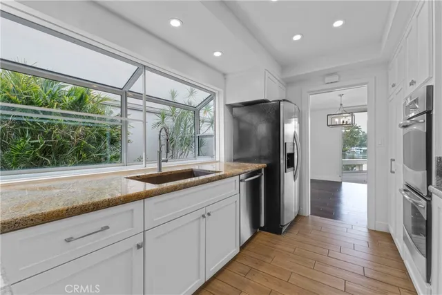 a kitchen with a refrigerator and a sink