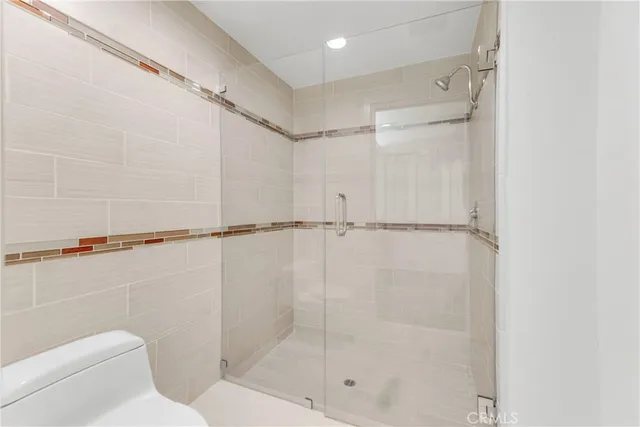 a bathroom with a shower and toilet