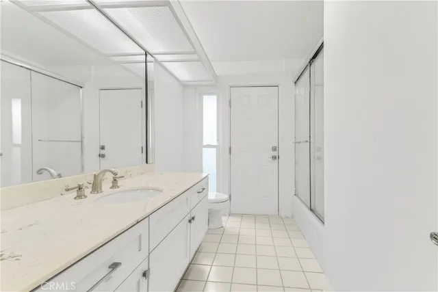 a spacious bathroom with a shower sink and mirror