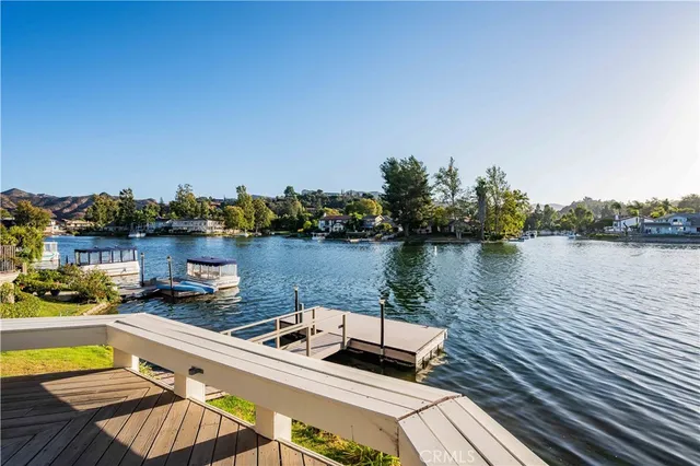 a view of a lake with couches chairs and a table