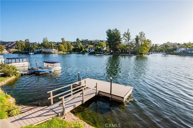 a view of a lake with houses in the back