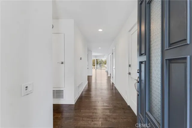 a view of a hallway with the wooden floor