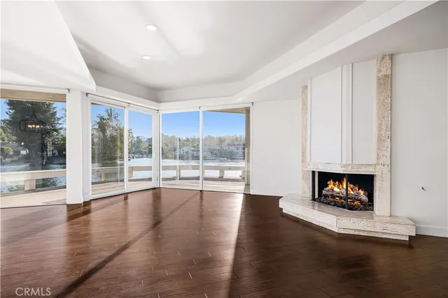 a living room with furniture wooden floor and a fireplace
