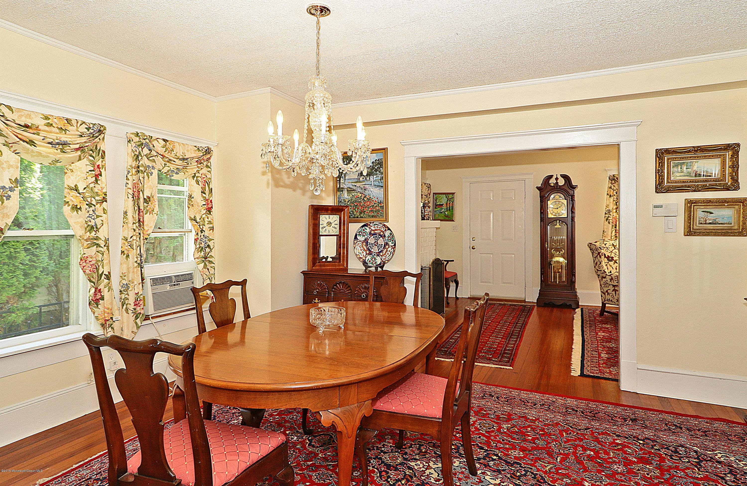 113 Rumson Road Little Silver, NJ 07739 - Photo 11 of 30 a dining room with furniture a chandelier and wooden floor
