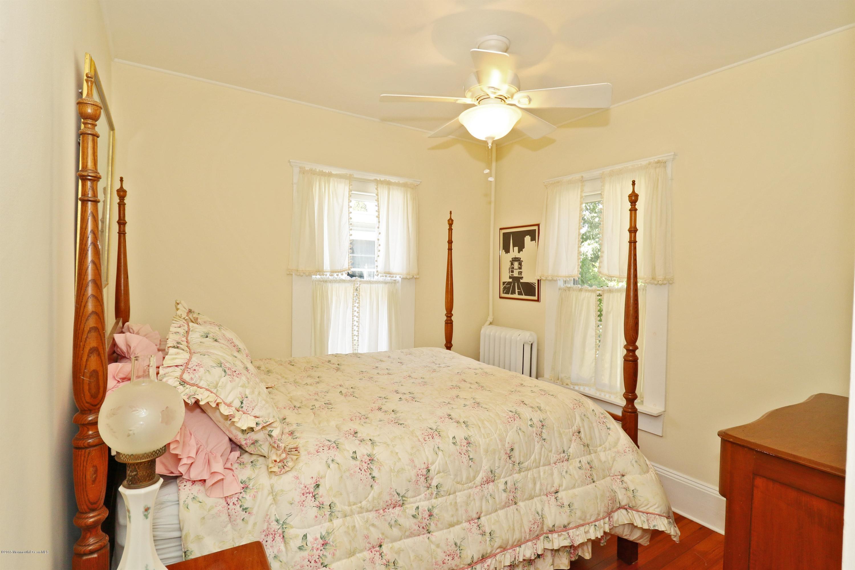 113 Rumson Road Little Silver, NJ 07739 - Photo 20 of 30 a bedroom with a bed and a chandelier