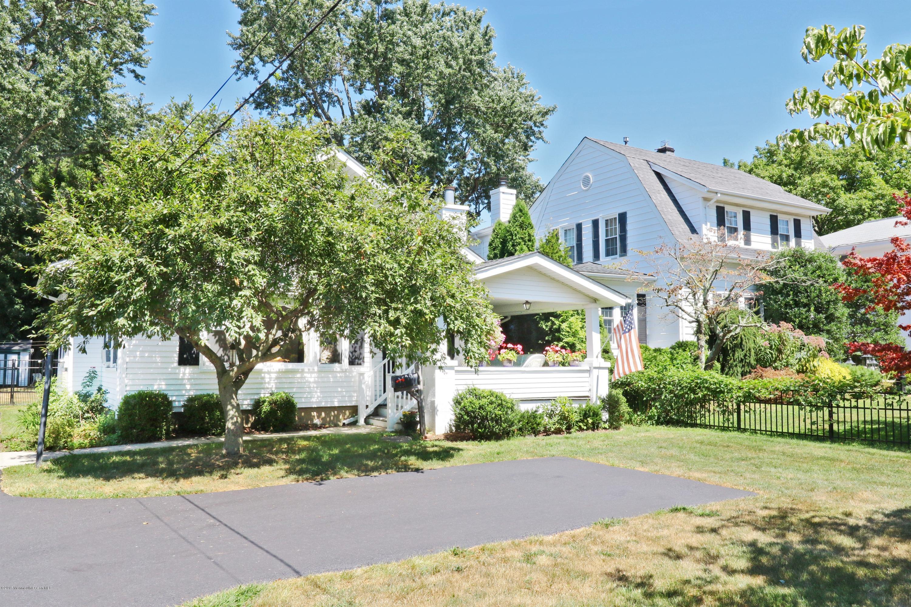 113 Rumson Road Little Silver, NJ 07739 - Photo 4 of 30 a front view of a house with a yard and garage