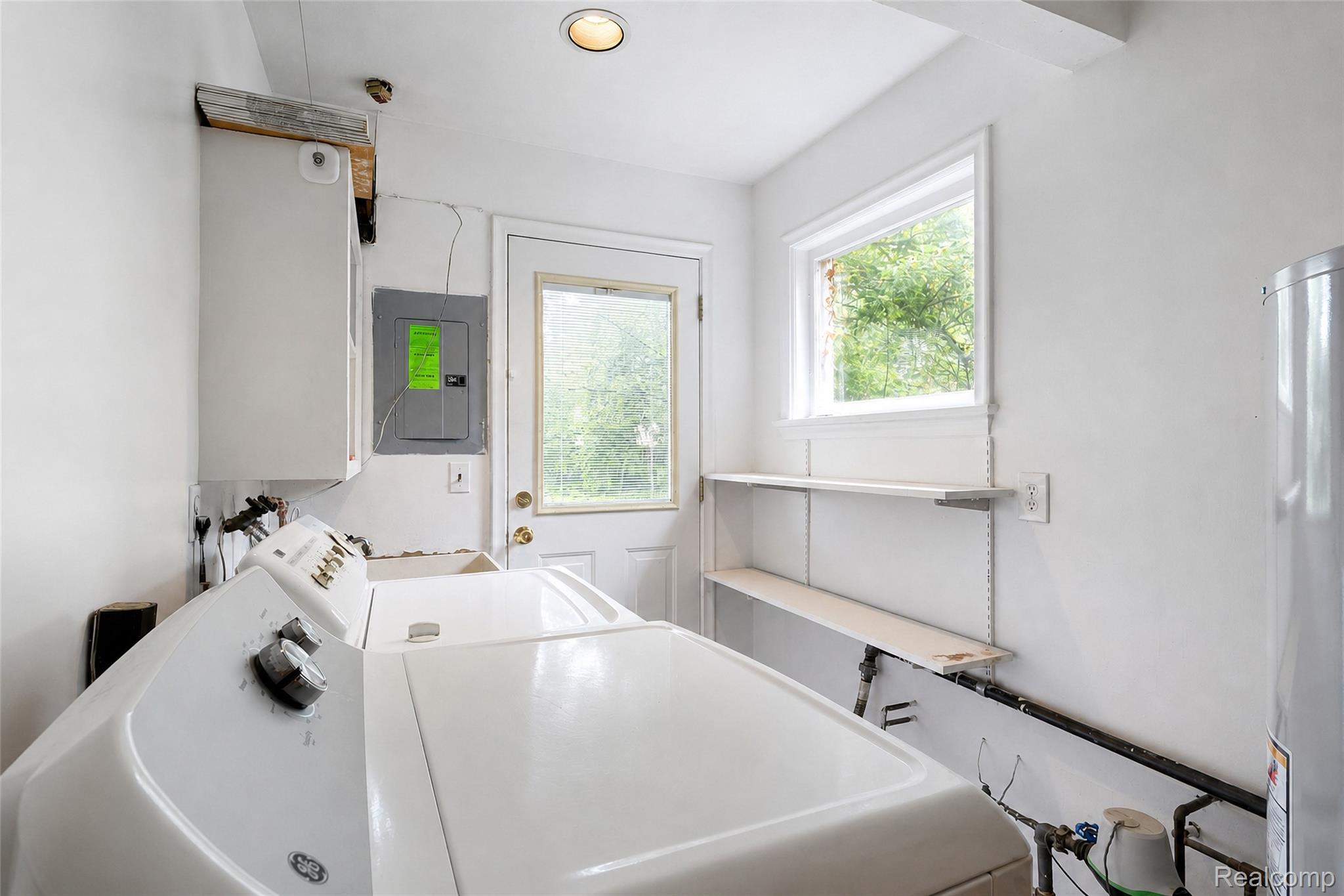 1846 Pembroke Road Birmingham, MI 48009 - Photo 27 of 37 Laundry area with recessed ceiling lighting, a rear entry door, and built-in shelving
