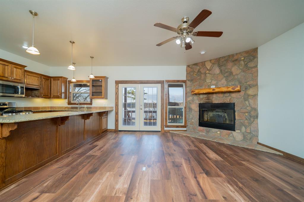 410 Private Road Leesburg, TX 75451 - Photo 11 of 38 a kitchen with stainless steel appliances granite countertop a stove top oven a sink with wooden floors