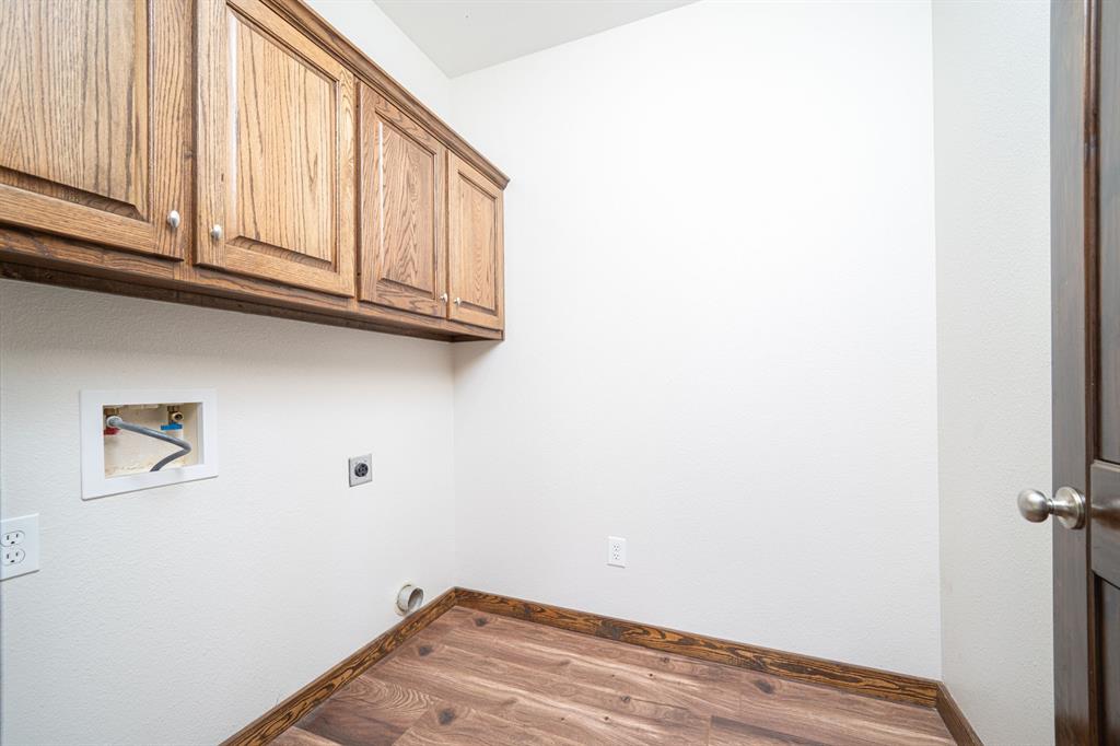 410 Private Road Leesburg, TX 75451 - Photo 14 of 38 a view of a closet area with wooden floor