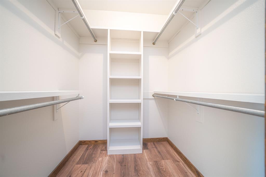 410 Private Road Leesburg, TX 75451 - Photo 19 of 38 a view of walk in closet with empty racks
