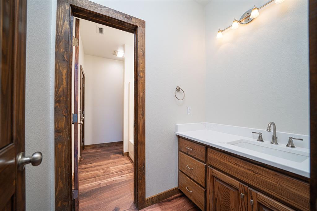 410 Private Road Leesburg, TX 75451 - Photo 20 of 38 a bathroom with a sink vanity and mirror