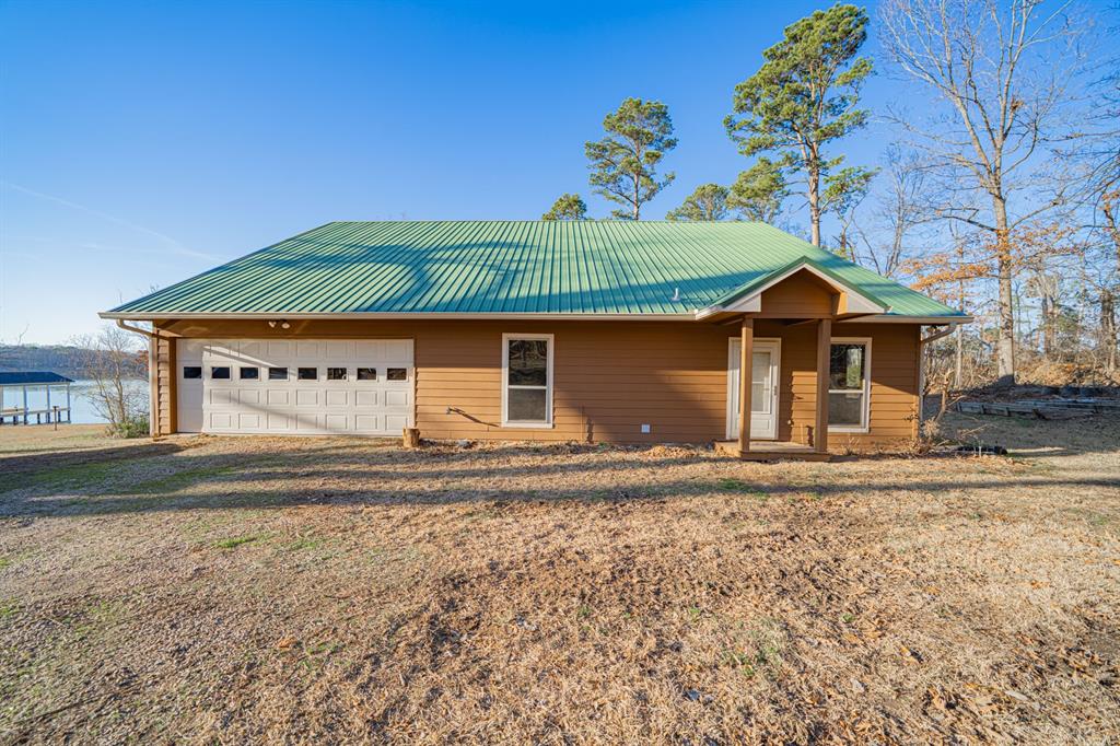 410 Private Road Leesburg, TX 75451 - Photo 2 of 38 a front view of a house with a garden