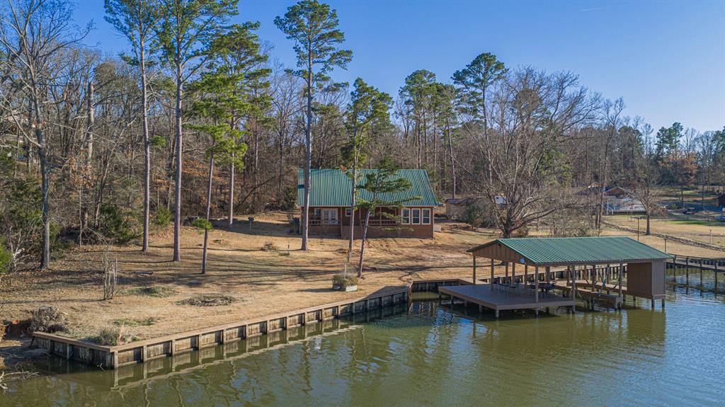 410 Private Road Leesburg, TX 75451 - Photo 26 of 38 a view of a lake with a house
