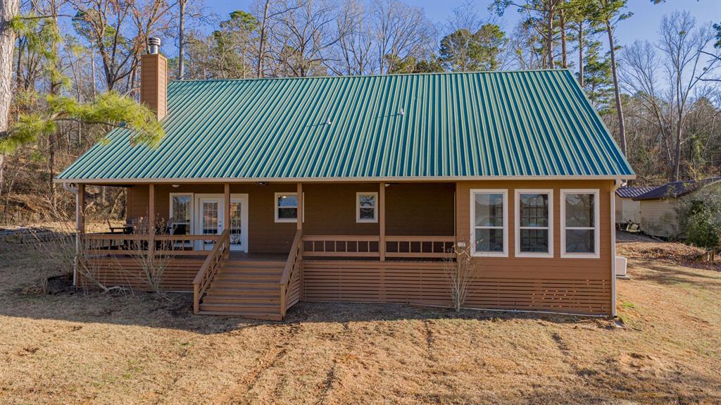 410 Private Road Leesburg, TX 75451 - Photo 3 of 38 a front view of a house with garden