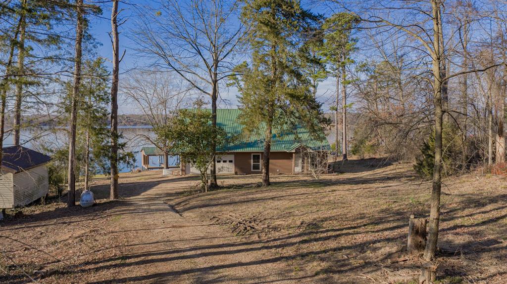 410 Private Road Leesburg, TX 75451 - Photo 33 of 38 a view of a house with a yard